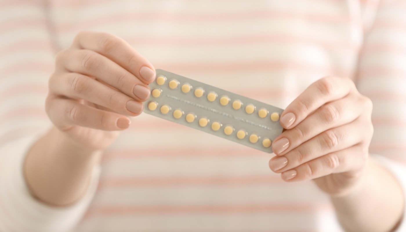 Woman holding a pack of contraceptive pills
